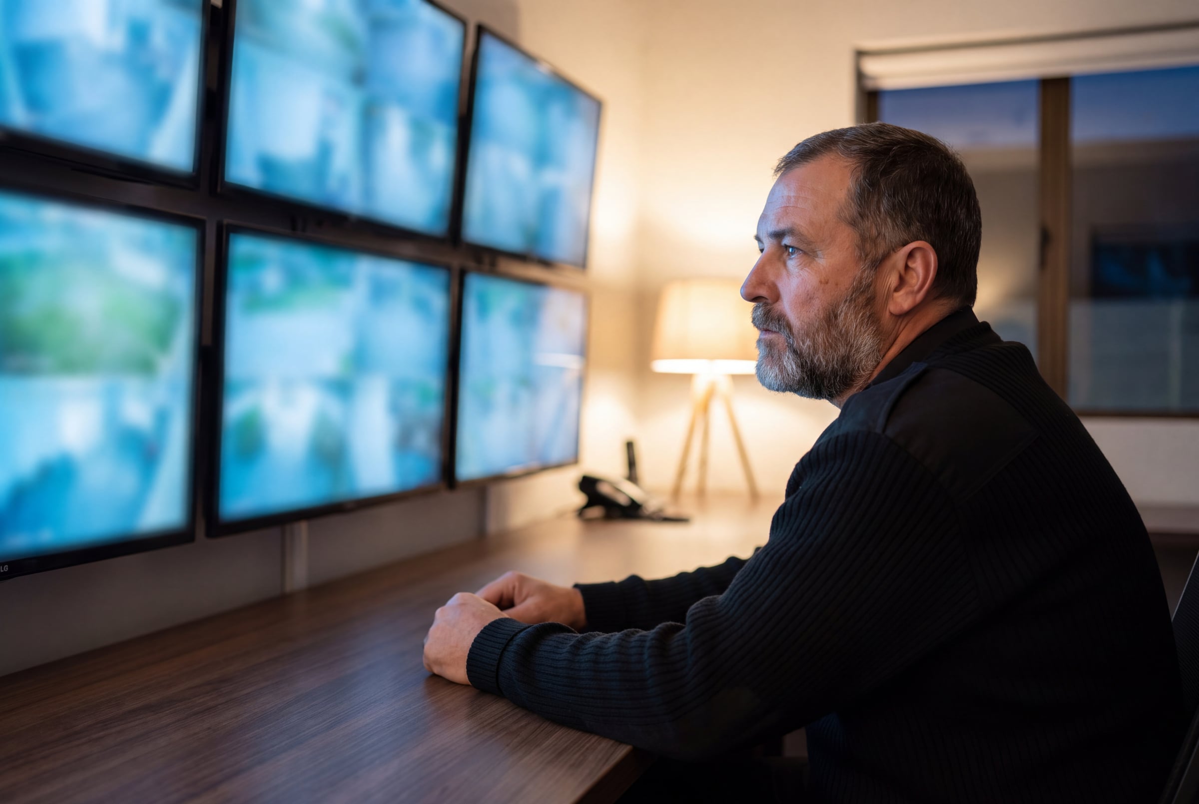A private security officer at a CCTV control desk